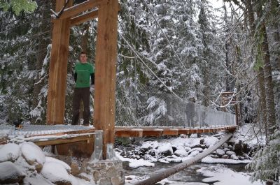 Andreas Thoni, Yellowhead Outdoor Recreation Association, stands on the new bridge over Swift Creek. The bridge is part of a vision to build the mountain biking network around Valemount.