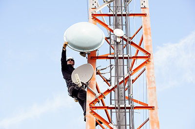 Ben Leslie of Columbia Wireless performs work on a tower overlooking Nelson. Photo credit: Colin Payne